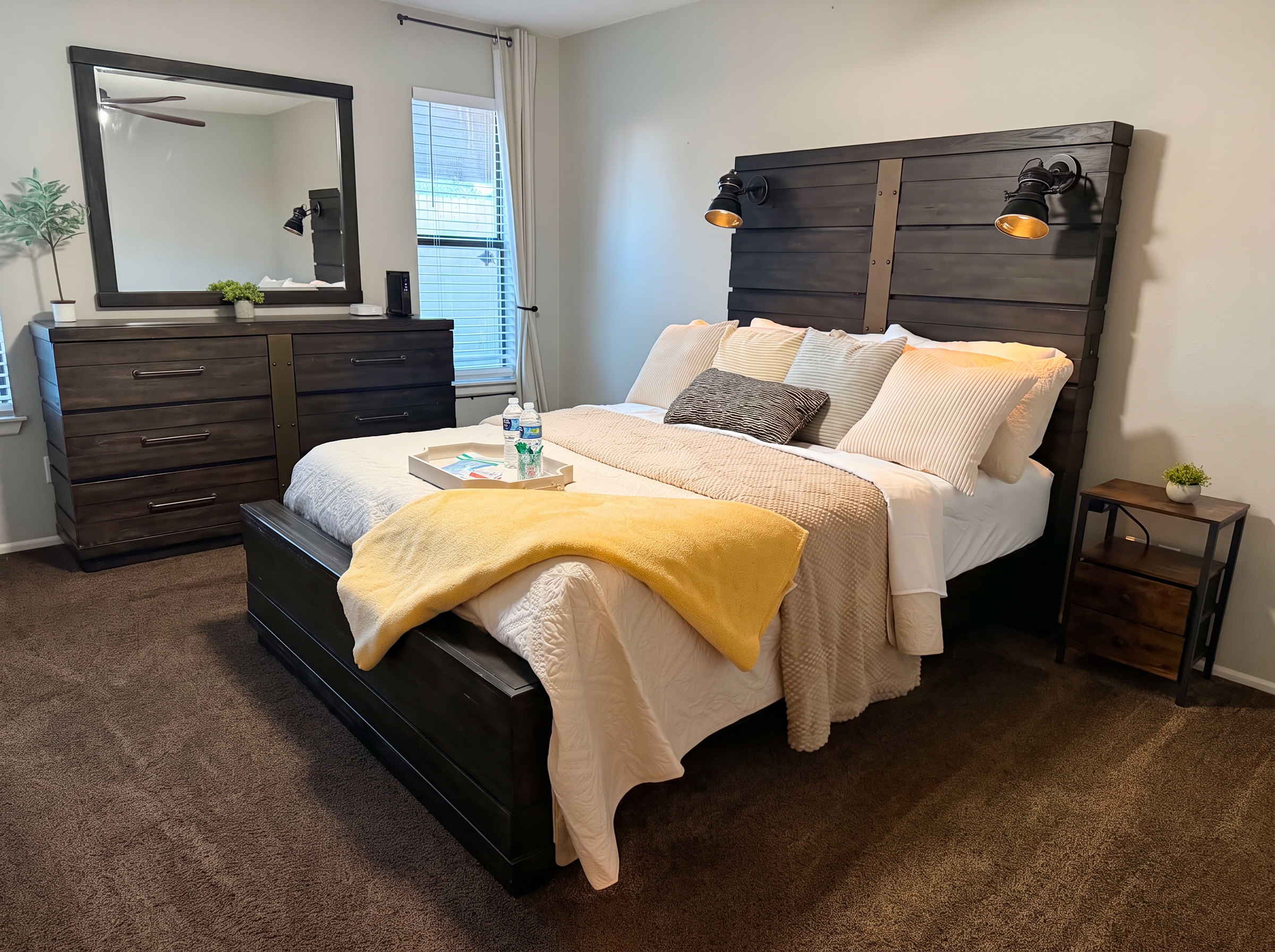 Primary bedroom at The Luxe Hideaway with queen bed and warm lighting
